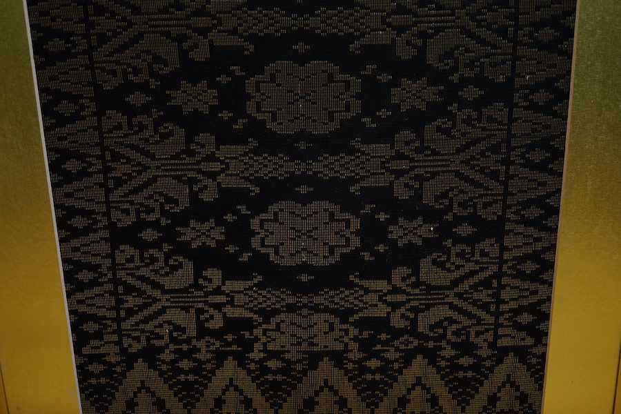 A framed 20th century black and gold brocade sample, possibly Thai 37cm x 97cm.